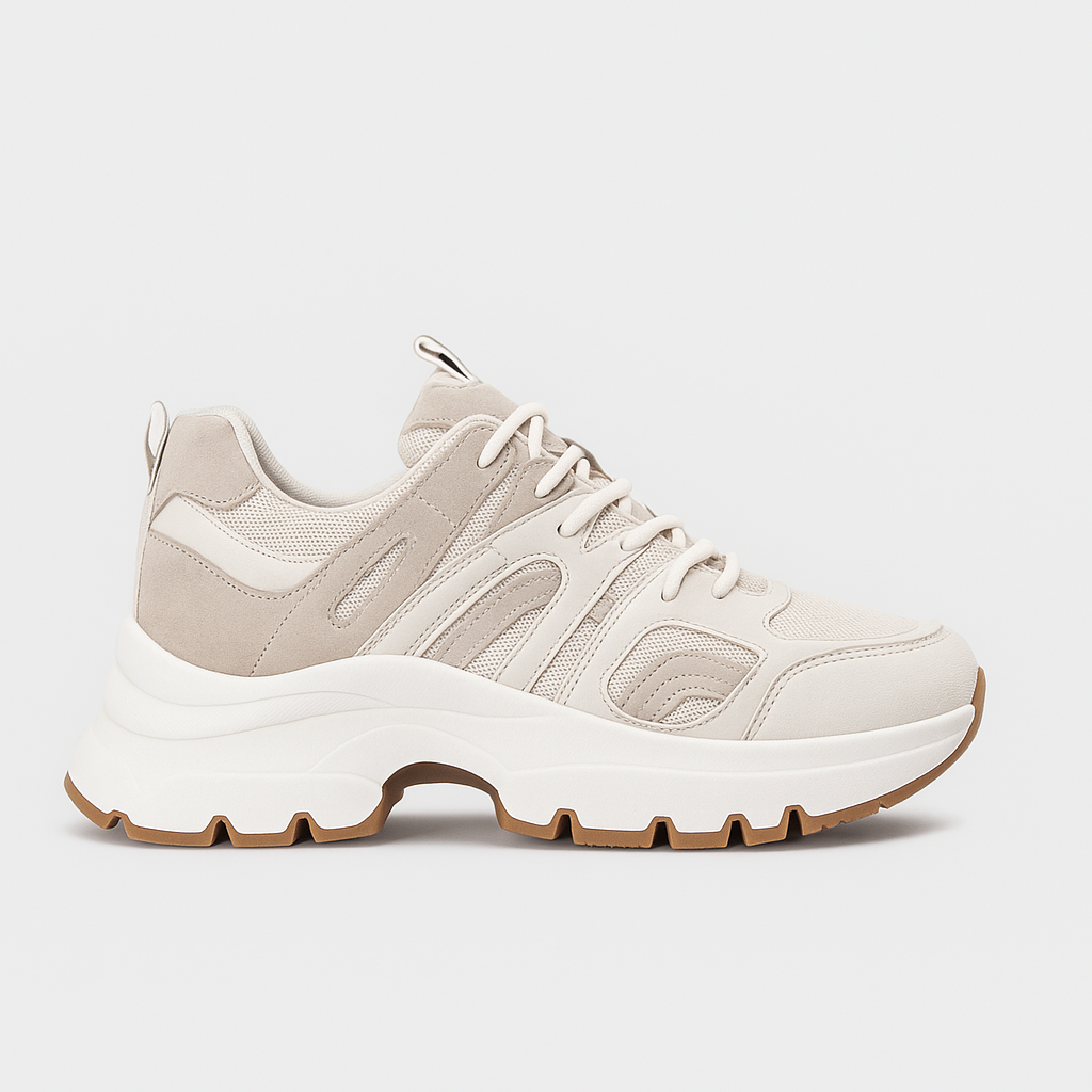 Chunky sneaker with lace-up closure, mesh panels, and thick textured sole.