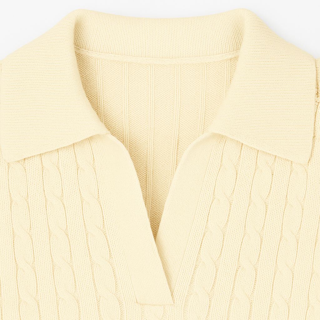 Cable-knit sweater with open collar neckline, long sleeves, and ribbed hems.