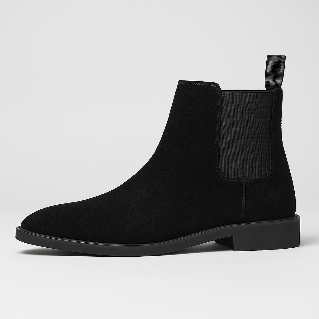 Suede Chelsea boot with elastic side panels, pull tab, and low heel design.